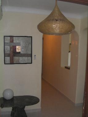 The hall has Moroccan lamps and table