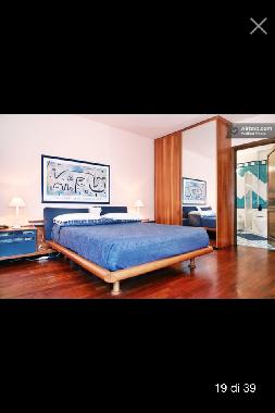 Large bedroom with private bathroom and jacuzzi balcony view park