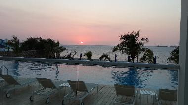 At your new holiday home at sunset. Drinking cocktails of course !