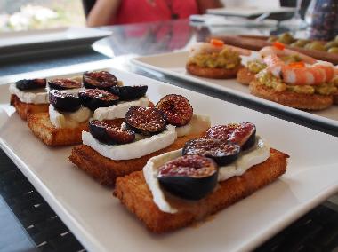 Homemade tostadas topped with baby figs and warmed goats cheese