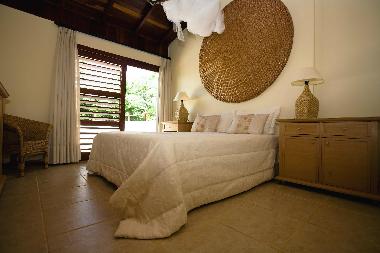 Master bedroom with doors to sun terrace and en suite bathroom