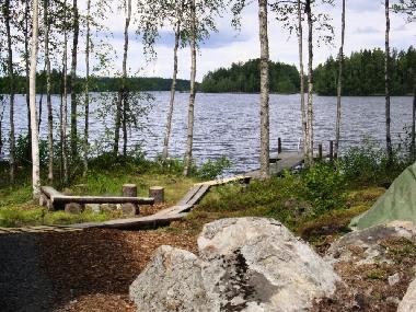 Path to the beach from the lakeside sauna and a campfire place right on the lake shore.