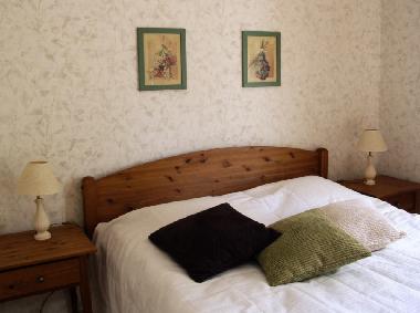 Bedroom with double bed and bedside tables.