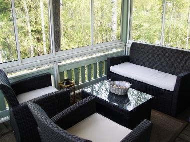 Terrace with sliding windows which protect you against the wind and mosquitoes