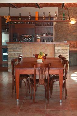 Living room with big wooden table and espresso bar