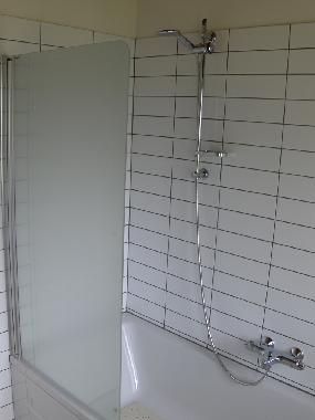 Shower and a large and nice bath. Bright colors in this room too