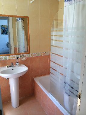 Bath with power shower overhead