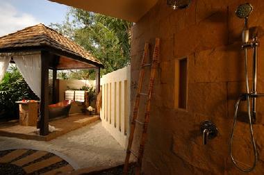 Open air bathroom with shower and a private bathtub