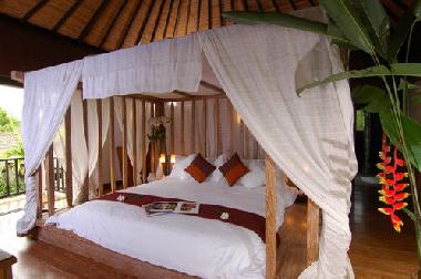 White suite with a private balcony overlooking the central pool