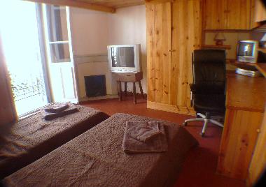 Wooden bedroom 2 single beds built in desk, wardrobe and cupboards and balcony