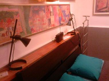 A shelf behind the double bed in the bedroom!