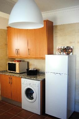 In the kitchen you find the washing machine, the refrigerator and microwave...