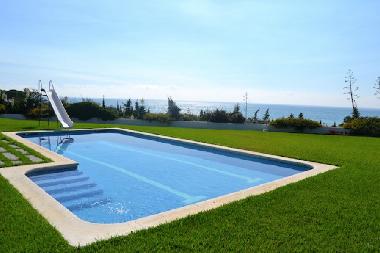 private swimming pool in front of the sea with toboggan