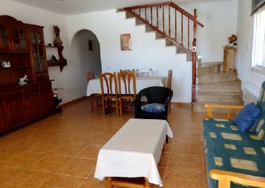 dining and living room with double sofabed right house