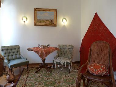 small living room with unique paintings, silverware, textiles and embroideries