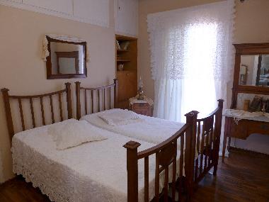 bedroom with two single beds, exceptional fabrics-curtains, hand-embroidered blankets and pillows