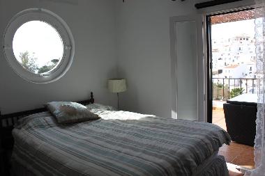 Master bedroom upstairs with the circular window.