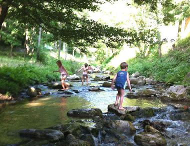 children playing by the river