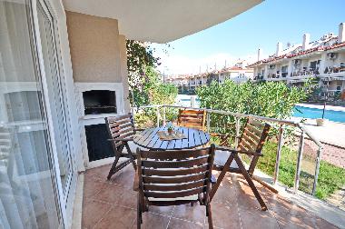 Terrace and BBQ of a one bedroom apartment. Direct access from the terrace to the pool area.