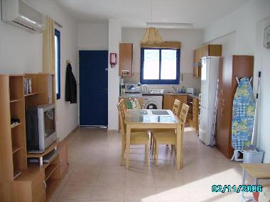 Dining and kitchen with front door