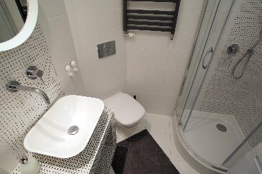 Bathroom with shower and washing machine