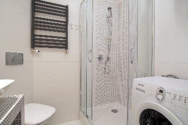 Bathroom with shower and washing machine