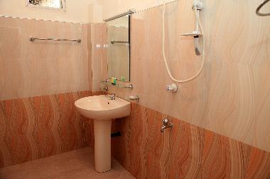 The modern bathroom is clean, fresh and includes many amenities