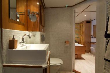 One of three en-suite bathrooms with shower, sink and toilet