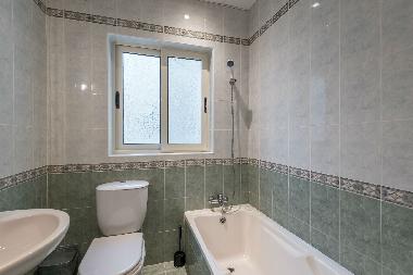 One bathroom has a bathtub