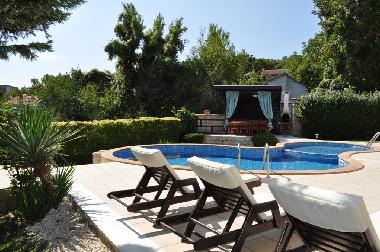 Pool area with sunlounges